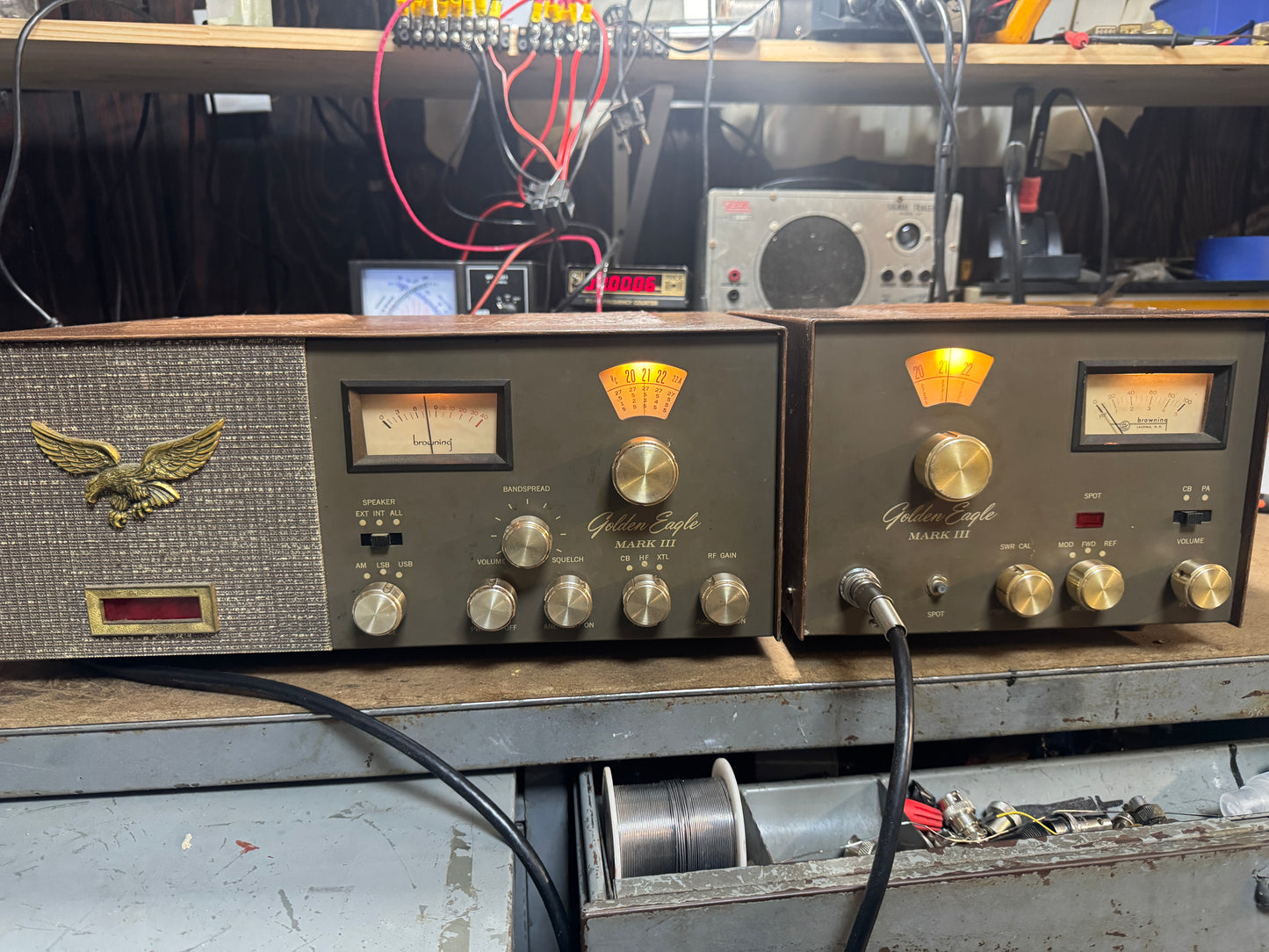 Vintage electronic equipment with knobs and dials on a workbench.
