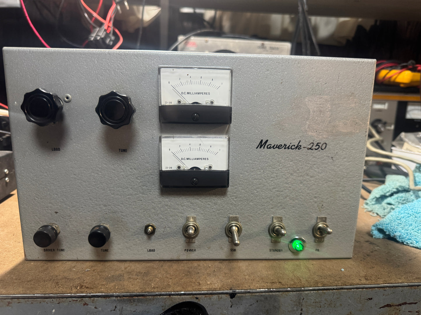 Electronic device labeled 'Maverick-250' with knobs and meters on a metallic surface.