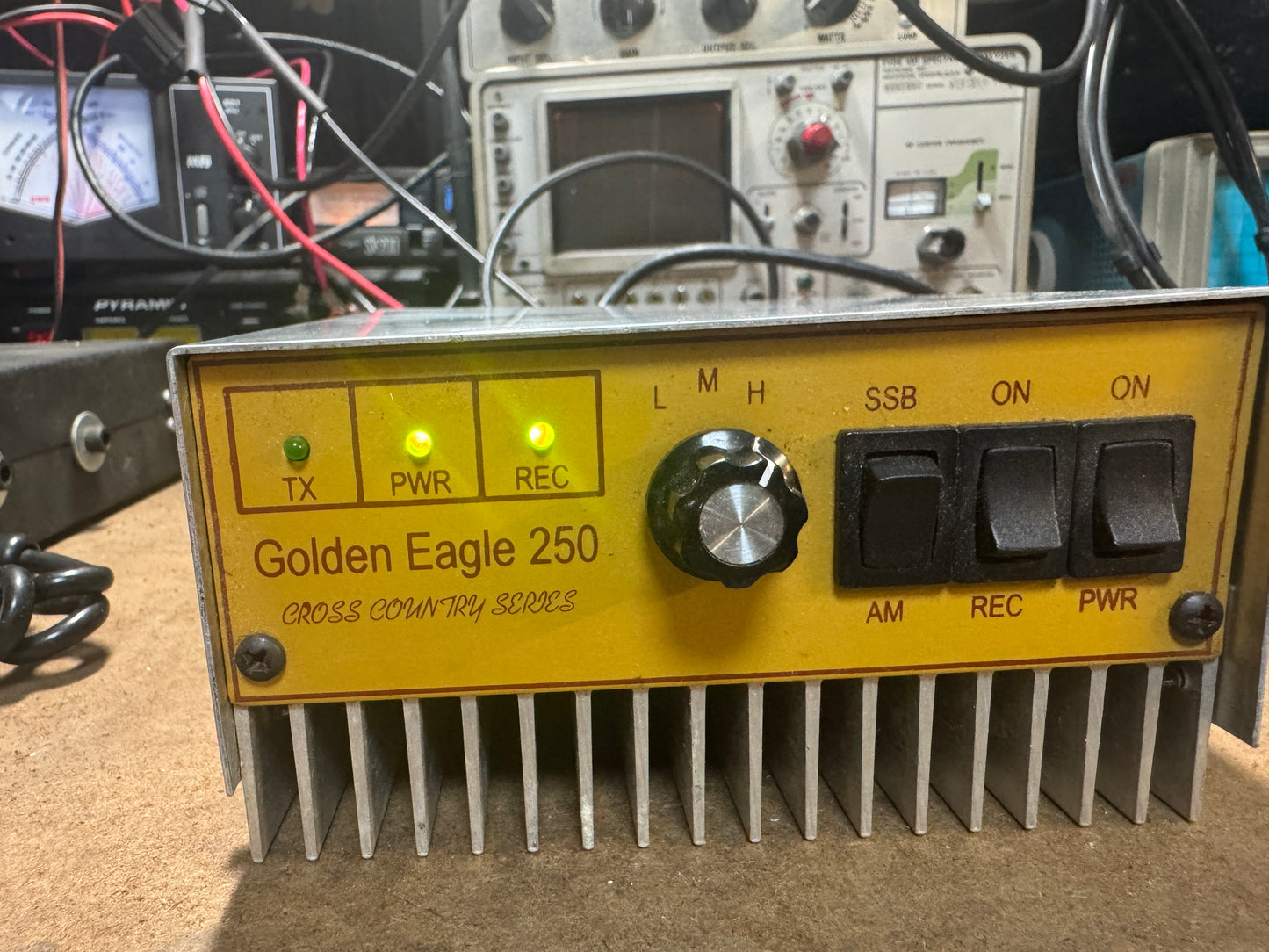 Radio receiver with 'Golden Eagle 250' branding on a technical setup background