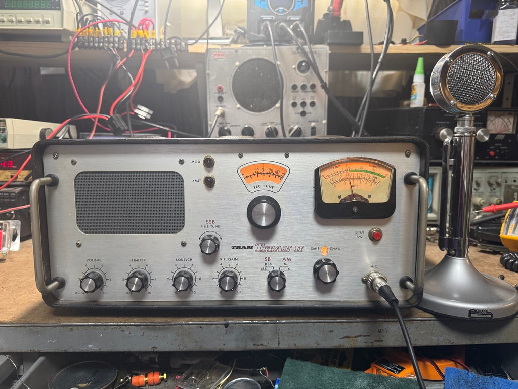 Vintage electronic equipment with dials and meters on a cluttered workbench