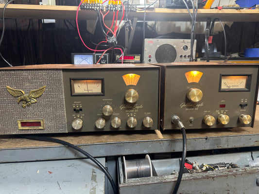 Vintage electronic equipment with knobs and dials on a workbench.