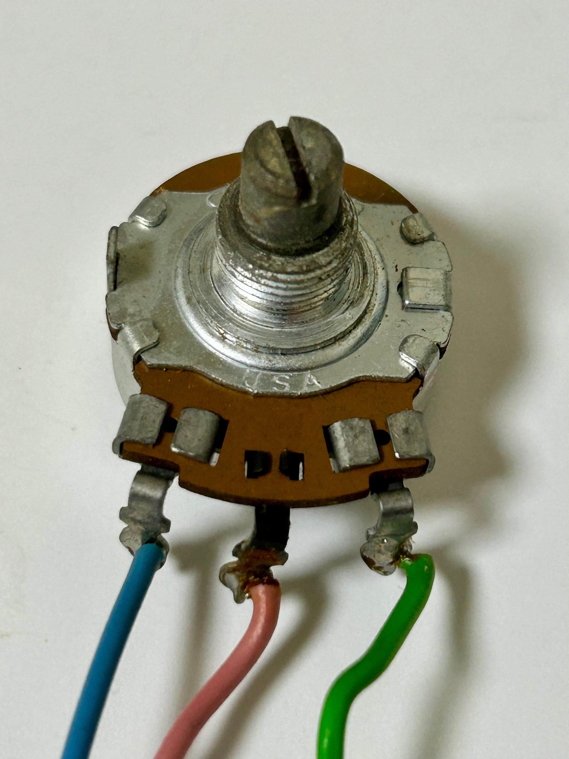 Potentiometer with three wires on a white background