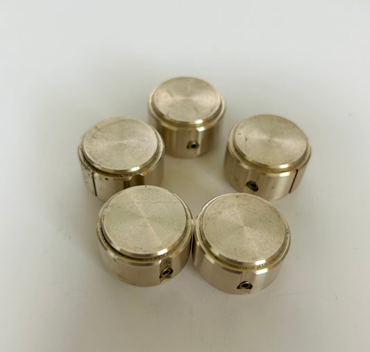 Five metallic cylindrical objects on a white background