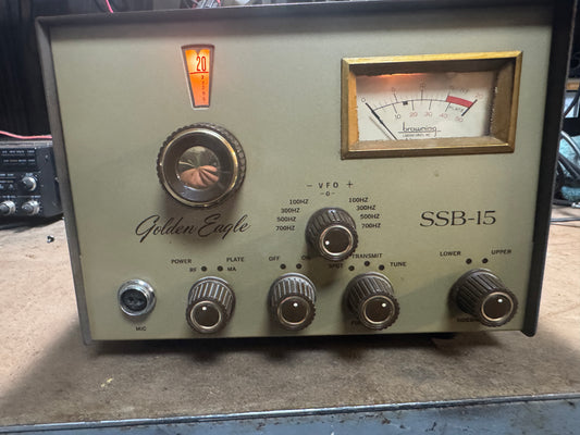 Vintage radio receiver with 'Golden Eagle' branding on a concrete surface