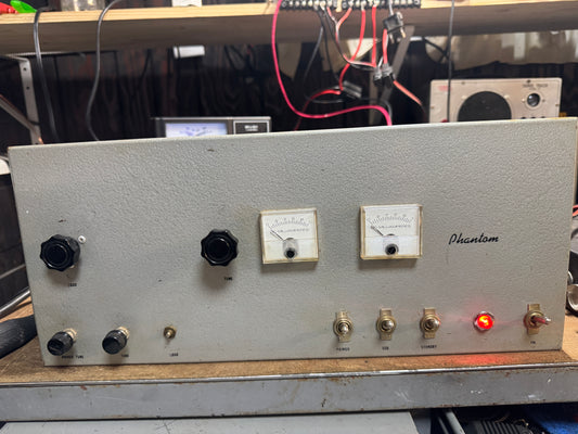 Electrical panel with various switches and indicators on a metallic surface.