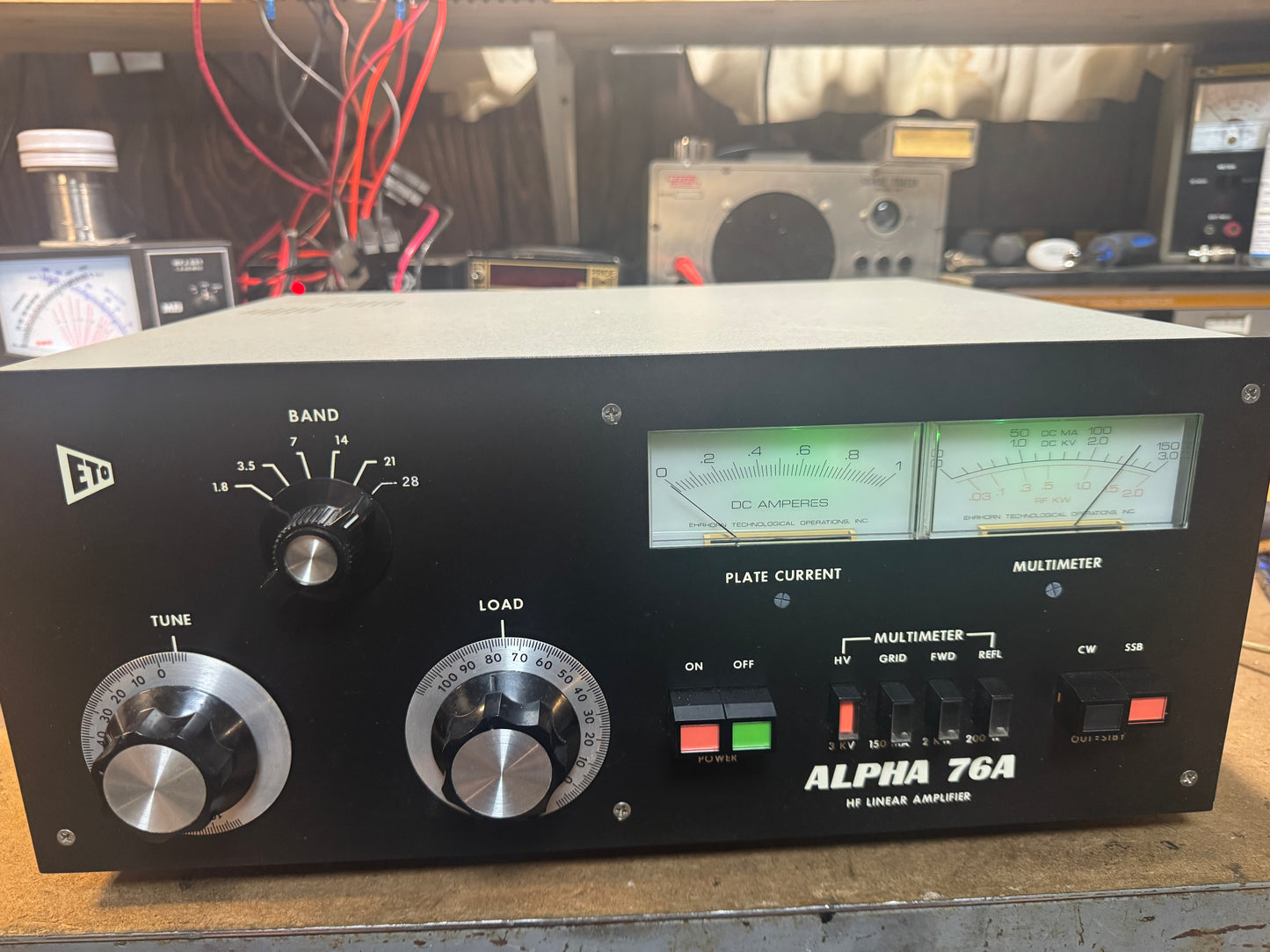 Vintage electronic amplifier with dials and display on a workbench