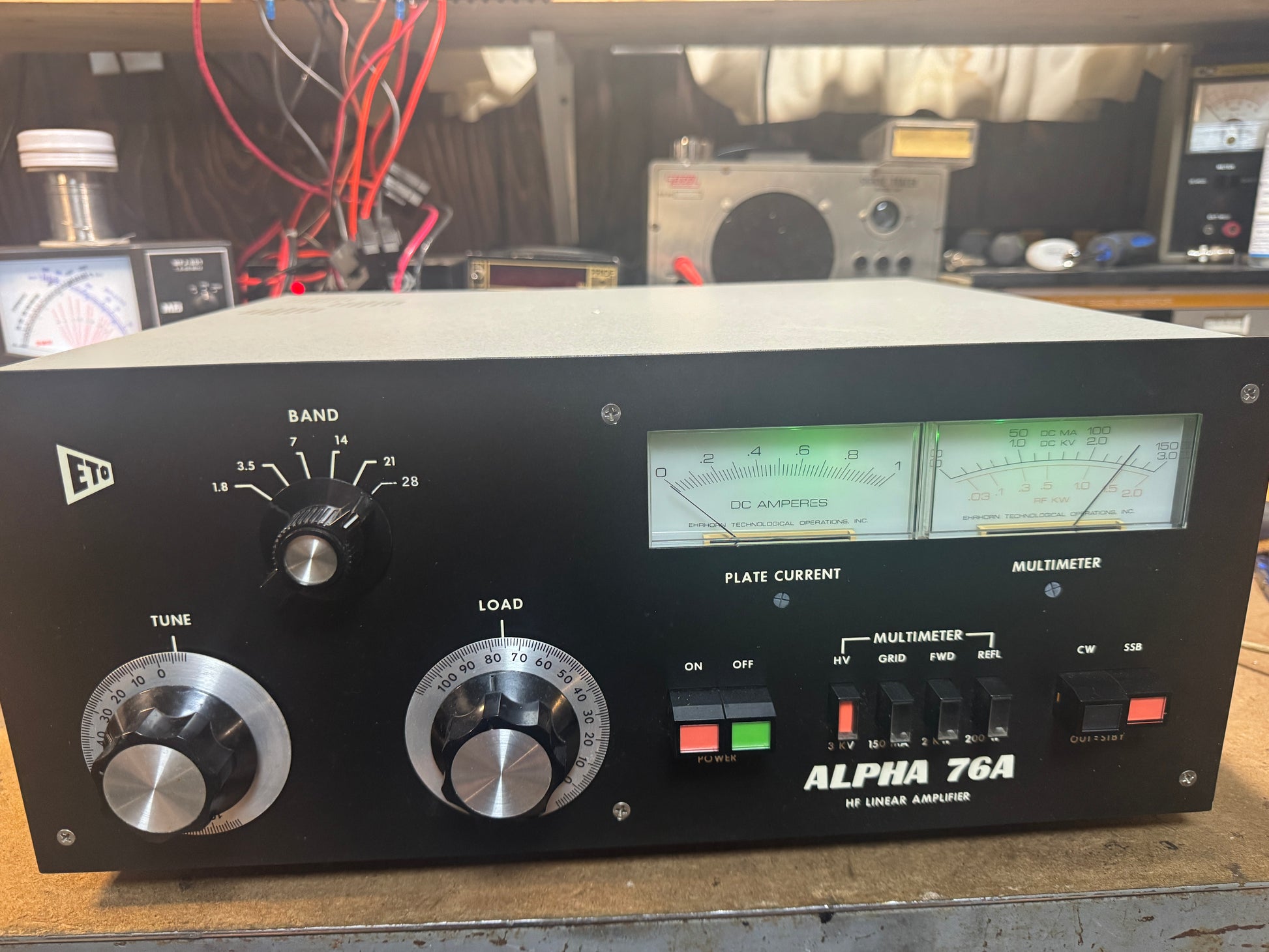 Vintage electronic amplifier with dials and display on a workbench