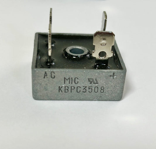 Electronic component with 'AC' and 'MIC KBPC3508' markings on a white background