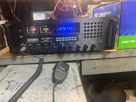 Radio receiver with digital display and microphone on a cluttered surface