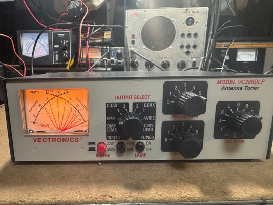 Antenna tuner with various controls and display on a beige surface