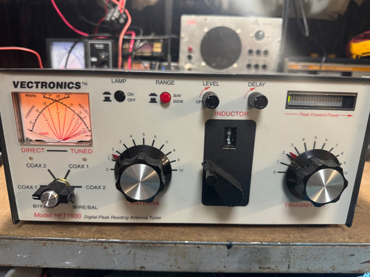 Vintage Vectronics radio receiver with various controls and display on a cluttered background